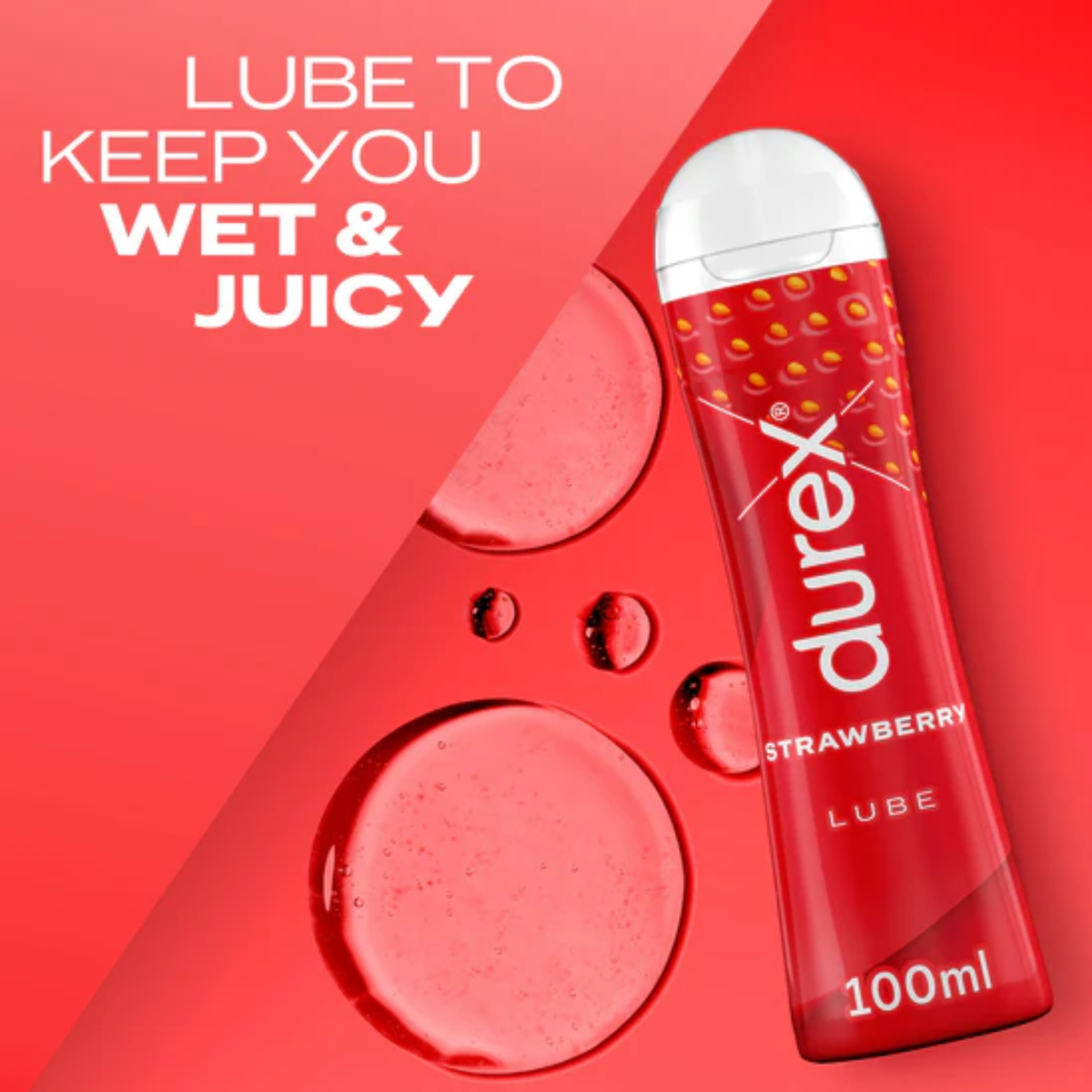 An image showing a red bottle of Durex Strawberry Lube, resting on a red surface, surrounded by droplets and large puddles of the clear lubricant. The text overlay reads: "LUBE TO KEEP YOU WET & JUICY".
