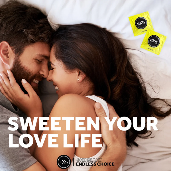 Lifestyle image of a smiling couple embracing closely in bed. Bold text overlay reads "SWEETEN YOUR LOVE LIFE," accompanied by two yellow EXS Banana condom wrappers in the upper corner.