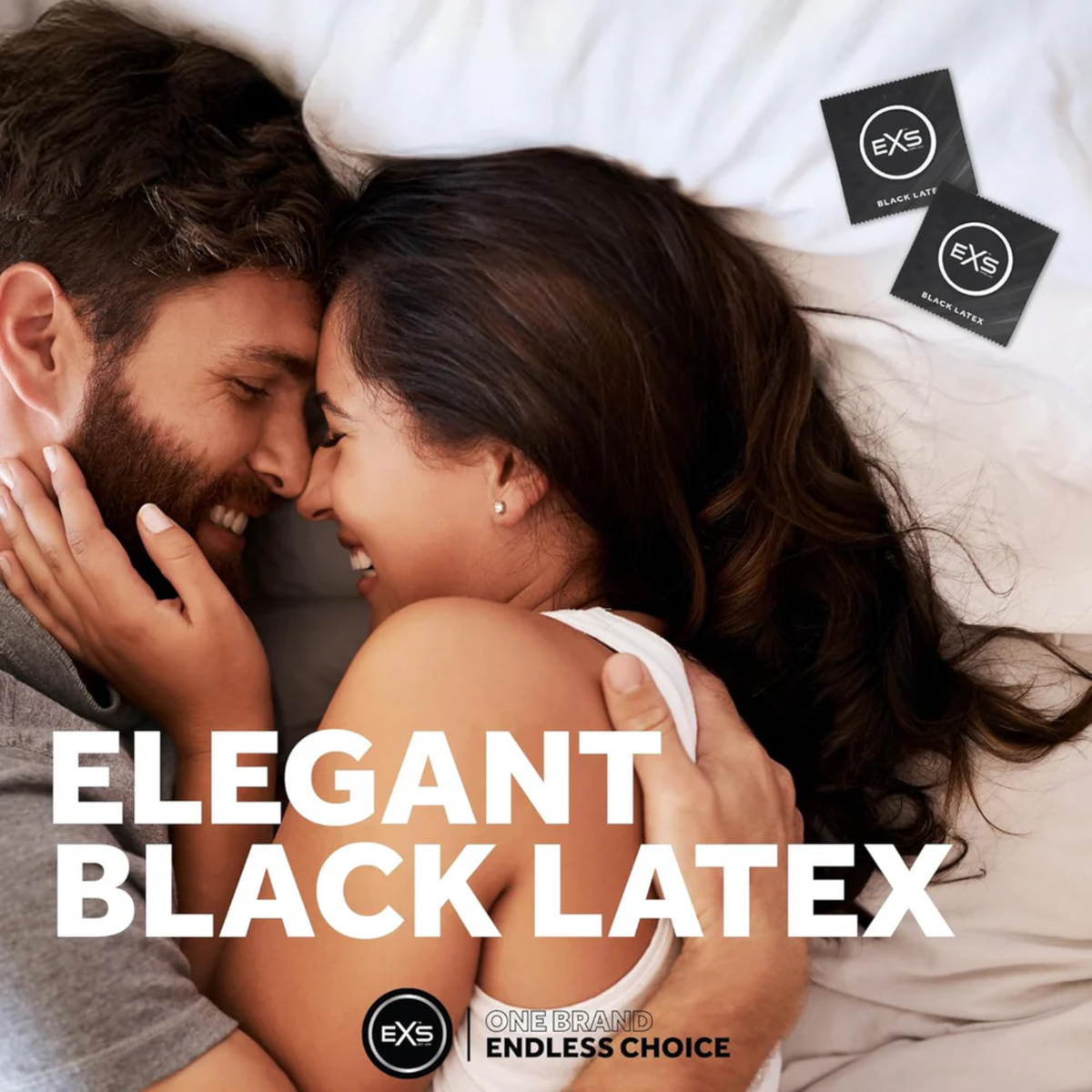 Lifestyle image of a smiling couple embracing closely in bed. Overlay text reads "ELEGANT BLACK LATEX," with two EXS Black Latex condom wrappers placed in the upper corner.