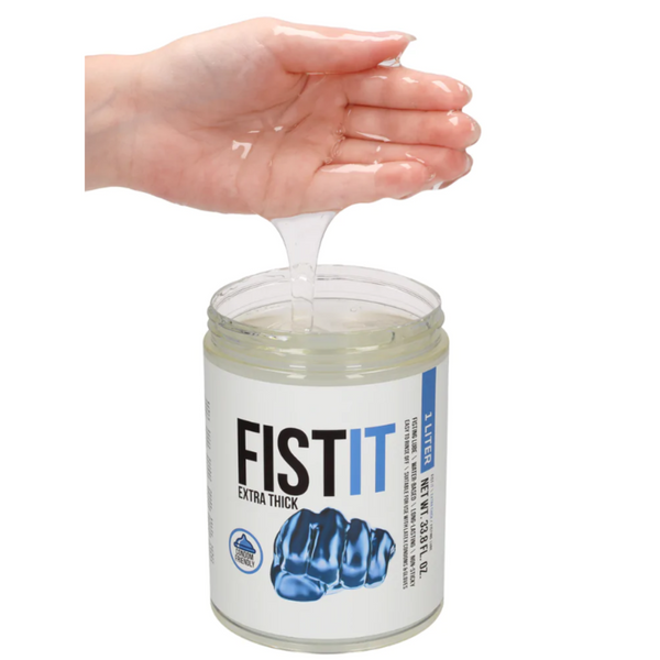 A hand scooping out the clear, extra thick water-based lubricant from the 1L jar, showing its consistency.