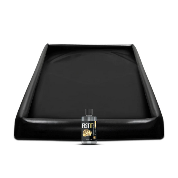 Black inflatable play sheet with raised edges, shown next to a bottle of FISTIT powder lubricant.