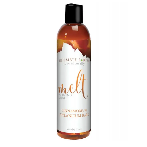 Front product view of the compact 60 ml (2 fl oz) amber bottle of Intimate Earth Melt Cinnamomum Zeylanicum bark warming glide.