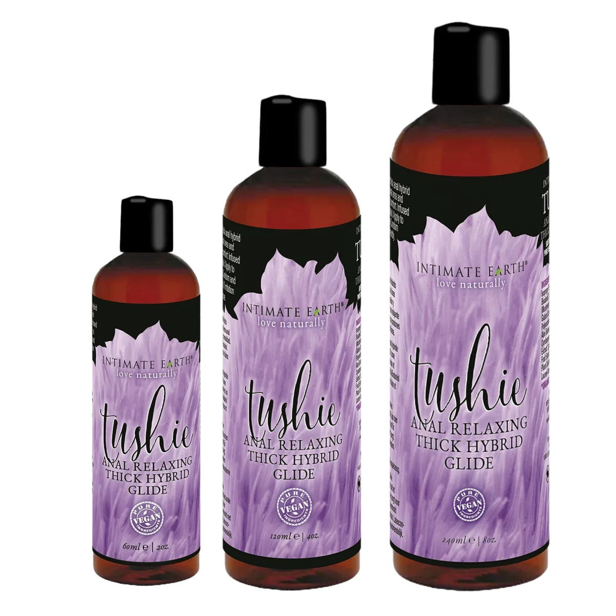 Size comparison view showing three amber bottles of Intimate Earth Tushie thick hybrid glide standing side by side in 60 ml (2 fl oz), 120 ml (4 fl oz), and 240 ml (8 fl oz) capacities. Main image