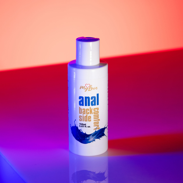 Front view of the 150 ml MyLove Anal Back Side Comfort bottle illuminated under dynamic pink and blue studio lighting.