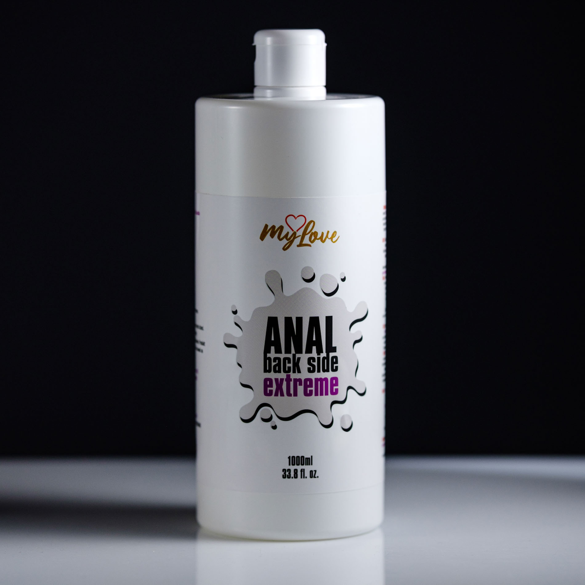 Front view of the 1000 ml MyLove Anal Back Side Extreme bottle standing centered on a white surface against a solid black background.