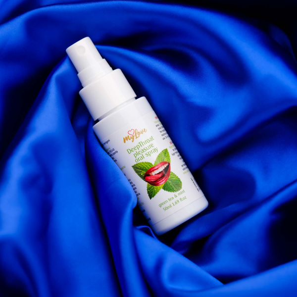The 50 ml bottle of MyLove Deep Throat Pleasure Oral Spray rests diagonally on draped, rich royal blue satin fabric.