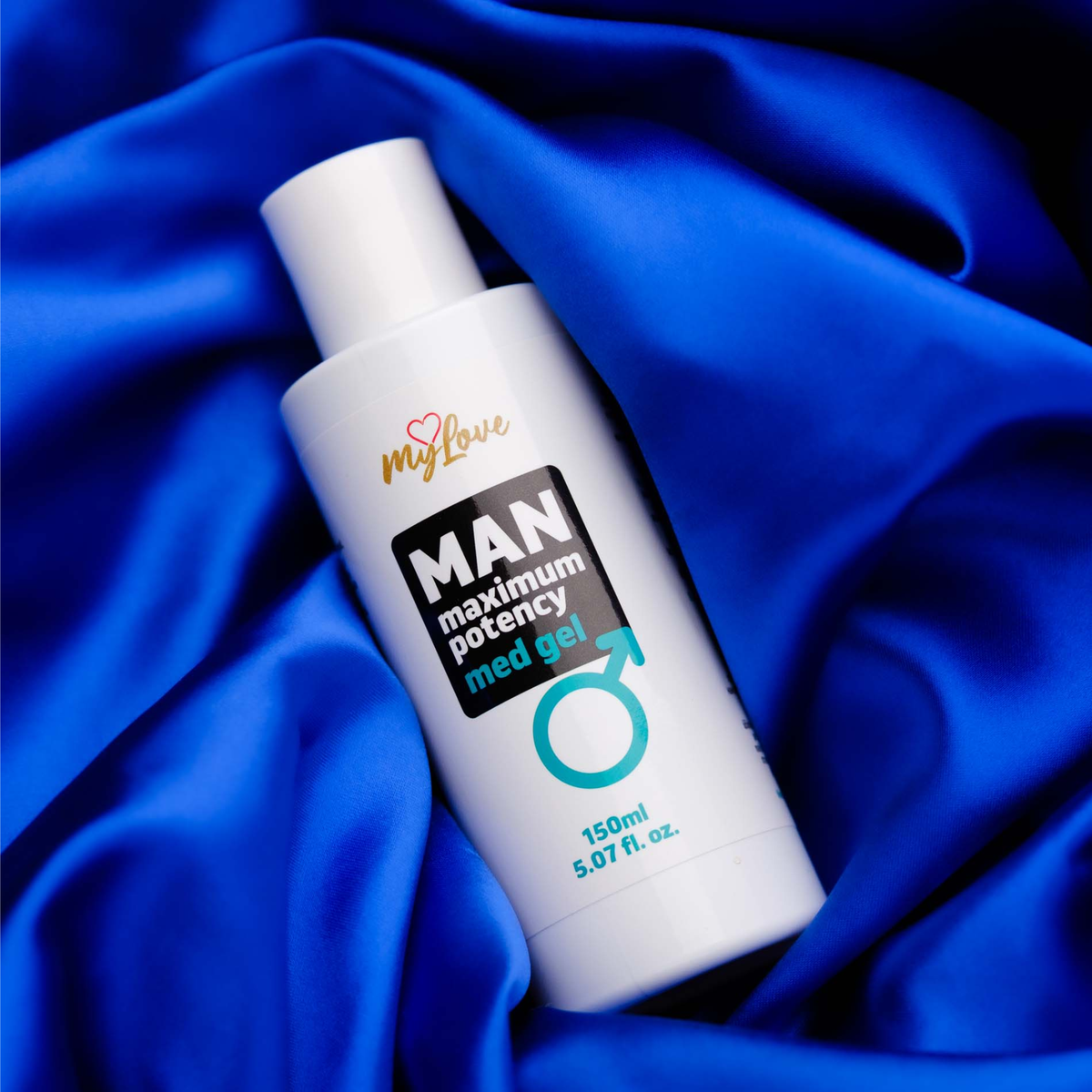 The 150 ml bottle of MyLove Man Maximum Potency Med Gel rests diagonally on draped, rich royal blue satin fabric.