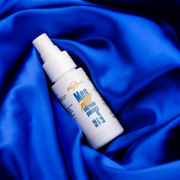 White spray bottle labeled 'myLion Men' on a blue fabric background