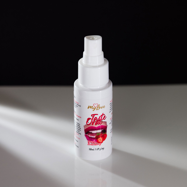 Front-angle view of the 50 ml MyLove Taste Oral Spray bottle standing on a white reflective surface against a solid black backdrop with soft side lighting.