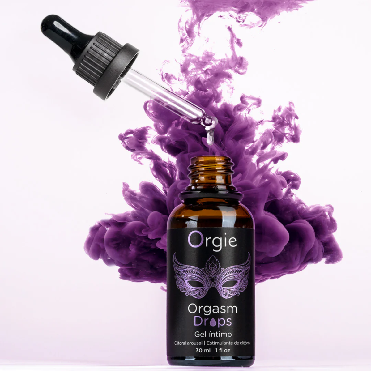 An amber glass dropper bottle of Orgie Orgasm Drops intimate gel against a white background, with a cloud of vibrant purple liquid swirling behind it.