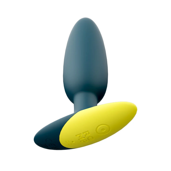 Bottom-up studio view of the teal ROMP Bass plug, detailing the bright yellow flared base with the embossed power button and "ROMP" logo.