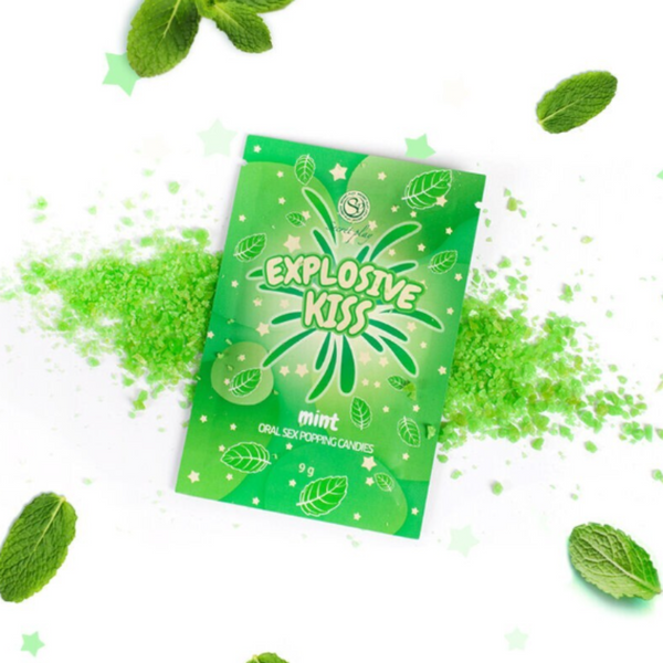 Green packaging of 'Explosive Kiss' mint-flavored product with scattered green powder and mint leaves on a white background.