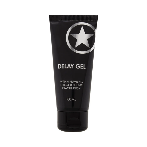 Front studio view of the 100 ml (3.38 fl oz) matte black squeeze tube of Shots Delay Gel featuring a silver star logo and white text stating "With a numbing effect to delay ejaculation"