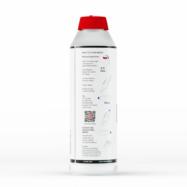 A back of a clear plastic bottle of X Lube powder lubricant. The bottle has a red cap and is primarily white with black text. The text provides mixing instructions under the heading "MIX IT TO YOUR NEEDS," including steps like "Add 1-2 screw caps of X Lube to a 0.5l / 16oz bottle" and "shake the bottle for 20sec." There's also a tip for letting it sit for 10 minutes and a warning not to use an electric mixer.