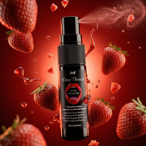 A close-up shot of the black intt Deep Throat Strawberry Oral spray bottle emitting a fine, misty spray from its nozzle. The bottle is surrounded by flying fresh strawberries, strawberry pieces, and glossy red droplets against a vibrant red backdrop.